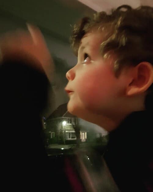 A still from an indie film, capturing a young actor in a moment of intense emotion. The setting is a dimly lit, realistic environment, highlighting the raw and genuine feel of independent cinema.