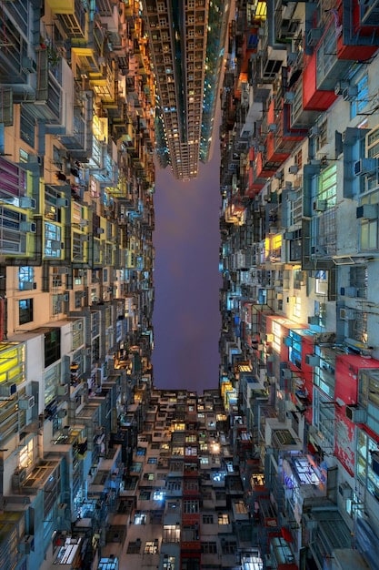 A detailed concept art image depicting a futuristic cityscape with holographic advertisements for various upcoming superhero movies. The architecture is sleek, and the overall vibe is modern and technologically advanced. Crowds of people are shown interacting with augmented reality displays.