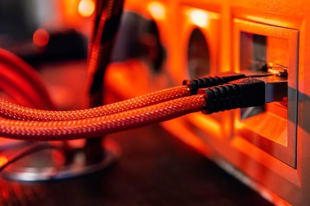 A close-up of an Ethernet cable plugged into the back of a gaming PC, with other cables neatly organized to emphasize a clean and efficient setup for reducing latency.