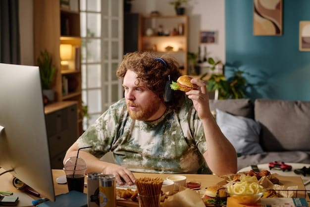 A person looking stressed at a computer surrounded by empty snack containers, emphasizing the potential negative impacts of excessive gaming on health and well-being.