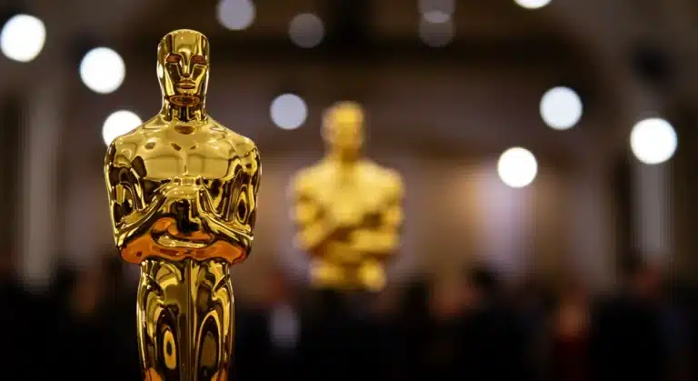 Golden Oscar statue on a red carpet, symbolizing cinematic achievement
